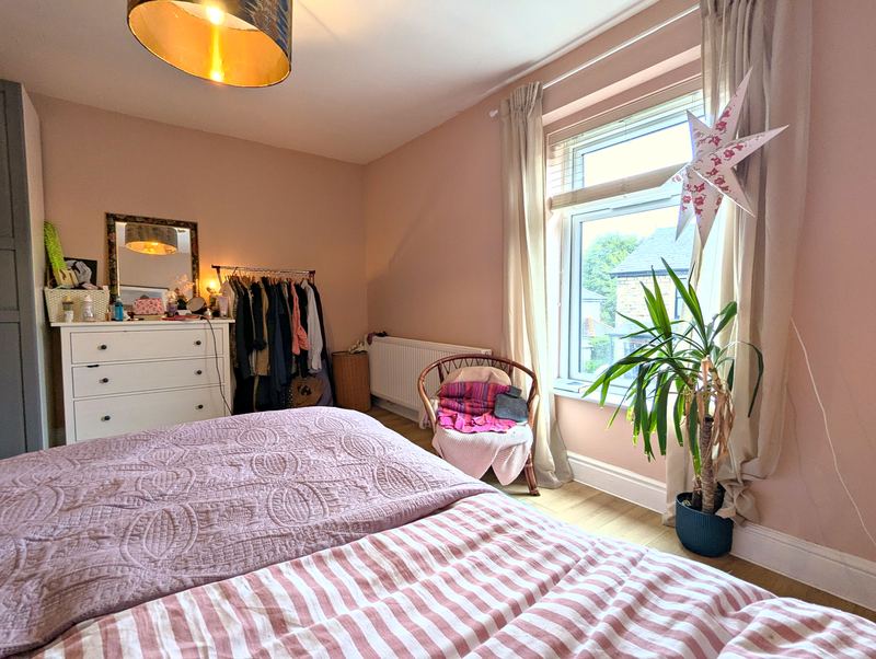 Bedroom 1 with a wardrobe, chest of drawers and a large window