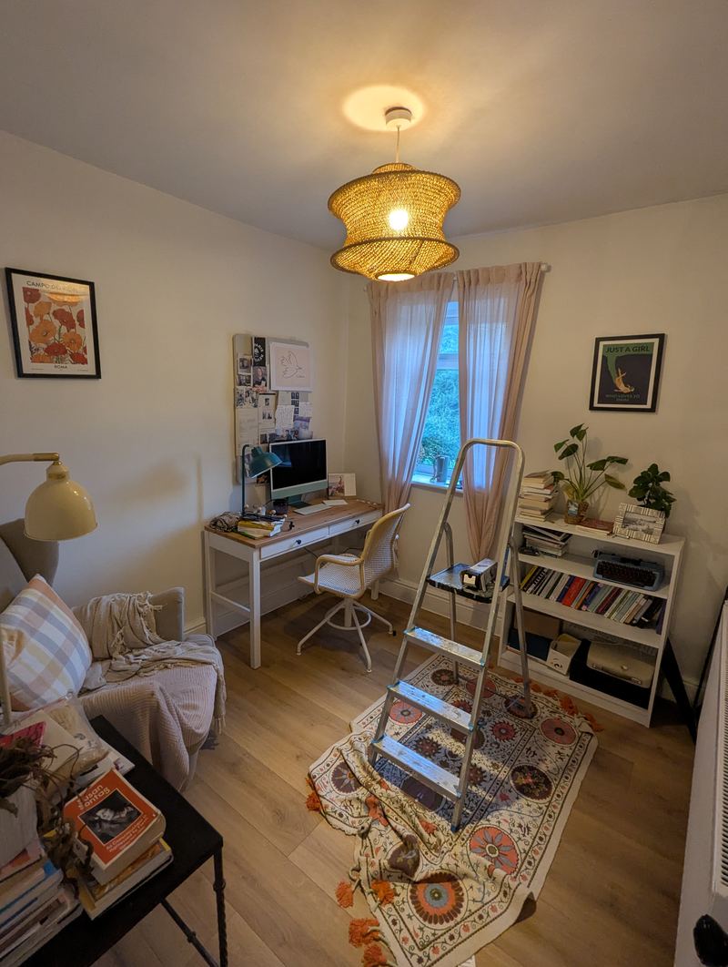 Bedroom 3 in use as a study, with a desk, bookshelves and a sofa beside a curtained window